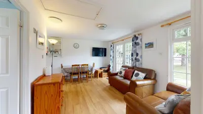 a living room with a couch and a table at 28 Tudor Court, Tolroy Manor in Hayle