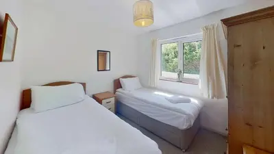 a bedroom with two beds and a window at D01 Vale Vue D1, Riviere Towans in Hayle