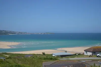 a view of a beach with a house and the ocean at D14 Ridgeway, Riviere Towans in Hayle