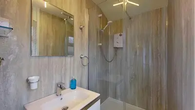 a bathroom with a shower and a sink and a shower at D14 Ridgeway, Riviere Towans in Hayle