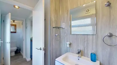 a bathroom with a sink and a mirror at D14 Ridgeway, Riviere Towans in Hayle