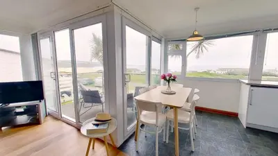 a kitchen and dining room with a table and chairs at D29 Westbourne, Riviere Towans in Hayle