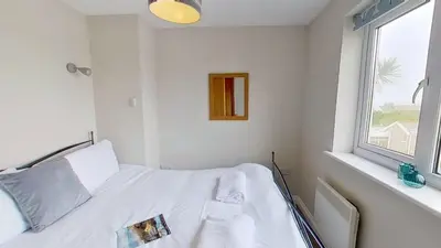a hospital room with a bed and a window at D29 Westbourne, Riviere Towans in Hayle