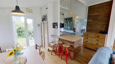 a kitchen with a counter with stools in it at D04 Hawaiian D4, Riviere Towans in Hayle