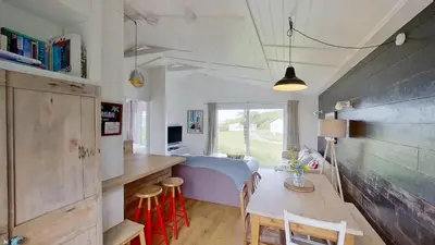 a kitchen and dining room with a table and chairs at D04 Hawaiian D4, Riviere Towans in Hayle