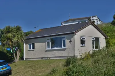 a house on a hill with a palm tree at D06 Heloan D6, Riviere Towans in Hayle