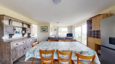 a kitchen and dining room with a table and chairs at D32 Chyanvean, Riviere Towans in Hayle