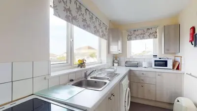 a kitchen with a sink and a microwave at D32 Chyanvean, Riviere Towans in Hayle