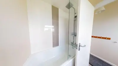 a shower with a glass door in a bathroom at D32 Chyanvean, Riviere Towans in Hayle