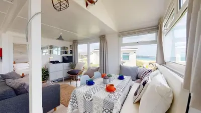 a living room with a couch and a table at D45 Medina, Riviere Towans in Hayle