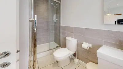 a bathroom with a toilet and a shower and a sink at D44 Pendarves, Riviere Towans in Hayle