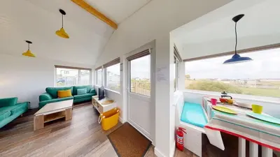 a room with a couch and a table at D38 Miramar, Riviere Towans in Hayle