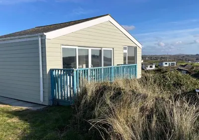 a small house sitting on top of a field at D39 St Margarets, Riviere Towans in Hayle