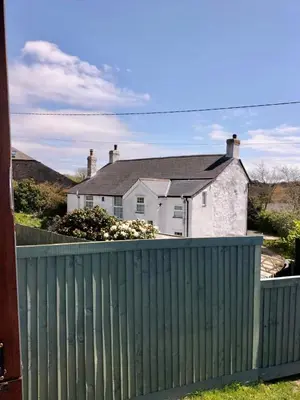 a green fence in front of a house at Fry’s Carriage in Scorrier