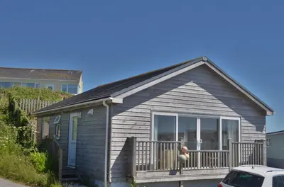 a small house with a porch and a balcony at D22 Sandelite, Riviere Towans in Hayle