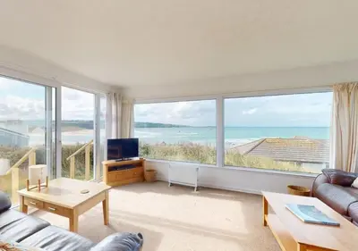 a living room with a view of the ocean at B42 Shilly Chalet, Riviere Towans in Hayle