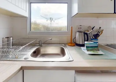 a kitchen counter with a sink and a window at B42 Shilly Chalet, Riviere Towans in Hayle