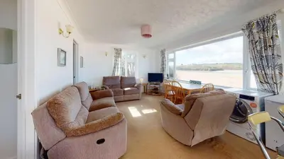 a living room with a couch and chairs and a window at C02 Lanta C2, Riviere Towans in Hayle