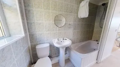a bathroom with a toilet and a sink and a bath tub at C02 Lanta C2, Riviere Towans in Hayle