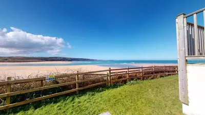 a view of the beach from the balcony of a house at C02 Lanta C2, Riviere Towans in Hayle