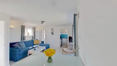 a living room with a blue couch and a table at C17 Sandyridge, Riviere Towans in Hayle