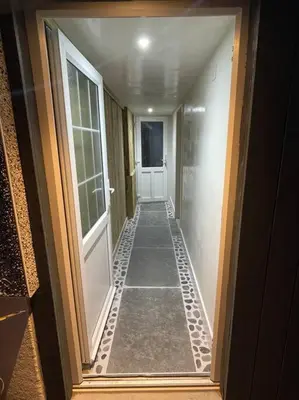 a hallway of a house with a door and a walk way at Self contained double bedroom with ensuite, private entrance, free parking , 5 min walk to beach in St Ives