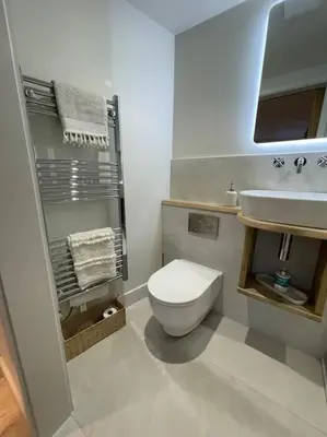 a bathroom with a white toilet and a sink at Self contained double bedroom with ensuite, private entrance, free parking , 5 min walk to beach in St Ives