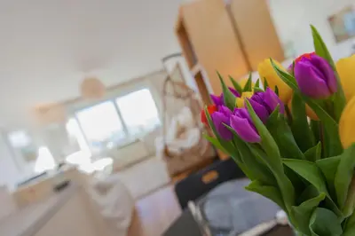 a vase filled with purple and yellow tulips at 13 Carrack Widden with complimentary spa passes in St Ives