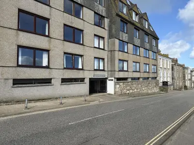 a building on the side of a street at 13 Carrack Widden with complimentary spa passes in St Ives