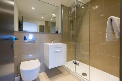 a bathroom with a toilet and a glass shower at Bamaluz in Carbis Bay