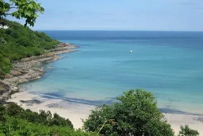 a view of a beach with a boat in the water at Bamaluz in Carbis Bay