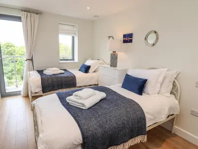 a bedroom with two beds and a window at Bamaluz in Carbis Bay
