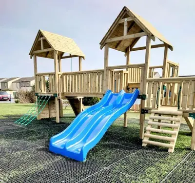 a playground with a blue slide and a gazebo at No.7 Perran View in St. Agnes