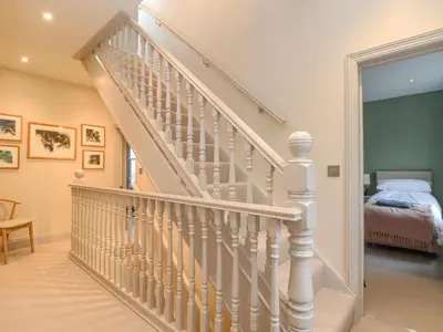 a staircase in a home with a bedroom at Treveddoe Farmhouse in Bodmin