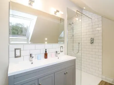 a bathroom with a sink and a shower at Treveddoe Farmhouse in Bodmin
