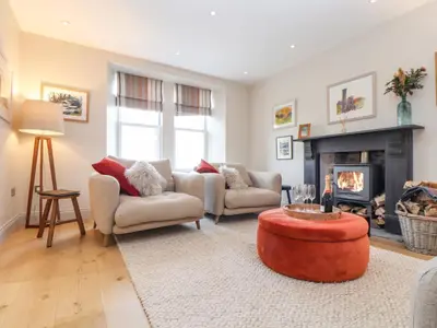 a living room with two couches and a fireplace at Treveddoe Farmhouse in Bodmin