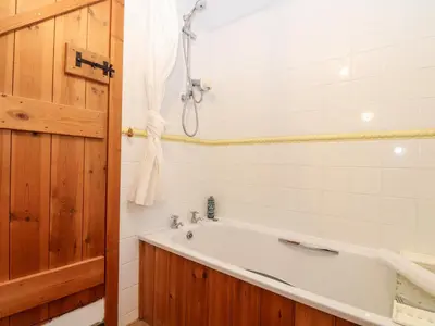 a bathroom with a bath tub and a shower at The Barley Crush in Bodmin
