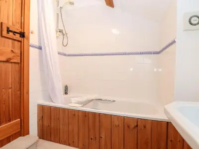 a bathroom with a bath tub and a sink at The Barley Crush in Bodmin