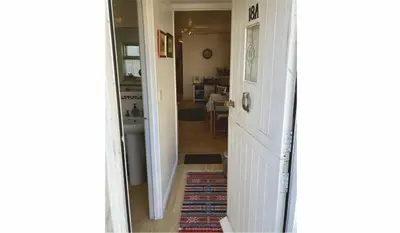 a hallway of a home with a door and a living room at The Sail Loft in Lostwithiel