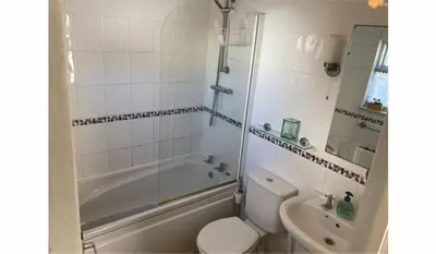 a bathroom with a toilet and a tub and a sink at The Sail Loft in Lostwithiel