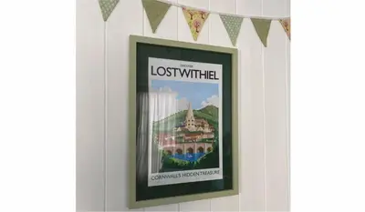 a picture of a lost white sign on a wall at The Sail Loft in Lostwithiel