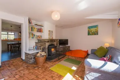 a living room with a couch and a fireplace at Hallagather Self Catering in Bude
