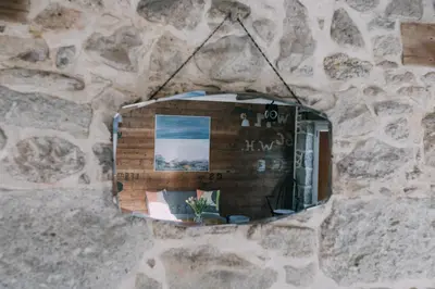 a mirror hanging on a stone wall at The Old Workshop in St Ives
