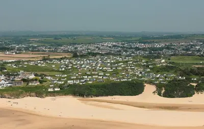an aerial view of a town on a sandy beach at D57 Bramble, Riviere Towans in Hayle