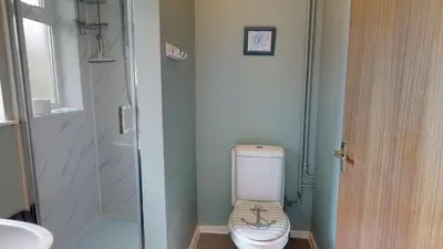 a small bathroom with a toilet and a sink at D57 Bramble, Riviere Towans in Hayle
