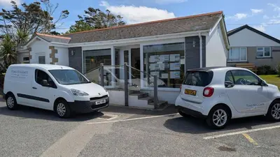 two white cars parked in front of a house at E08 Boness E8, Riviere Towans in Hayle