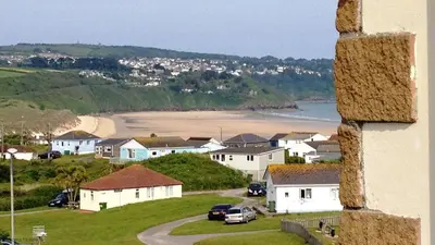 a view of a town with houses and a beach at E29 Bonnie Bank, Riviere Towans in Hayle