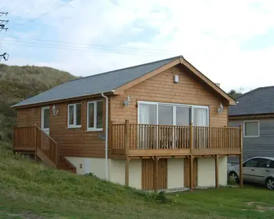 a house with a deck on a hill at E48 Redville, Riviere Towans in Hayle