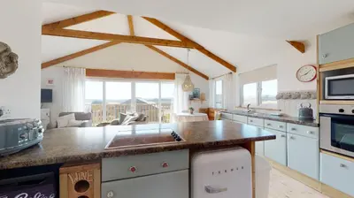 a kitchen with a counter with a sink in it at E48 Redville, Riviere Towans in Hayle