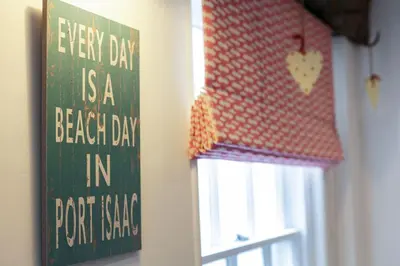 a sign that says every day is a beach day in front of a window at Church Hill House in Port Isaac